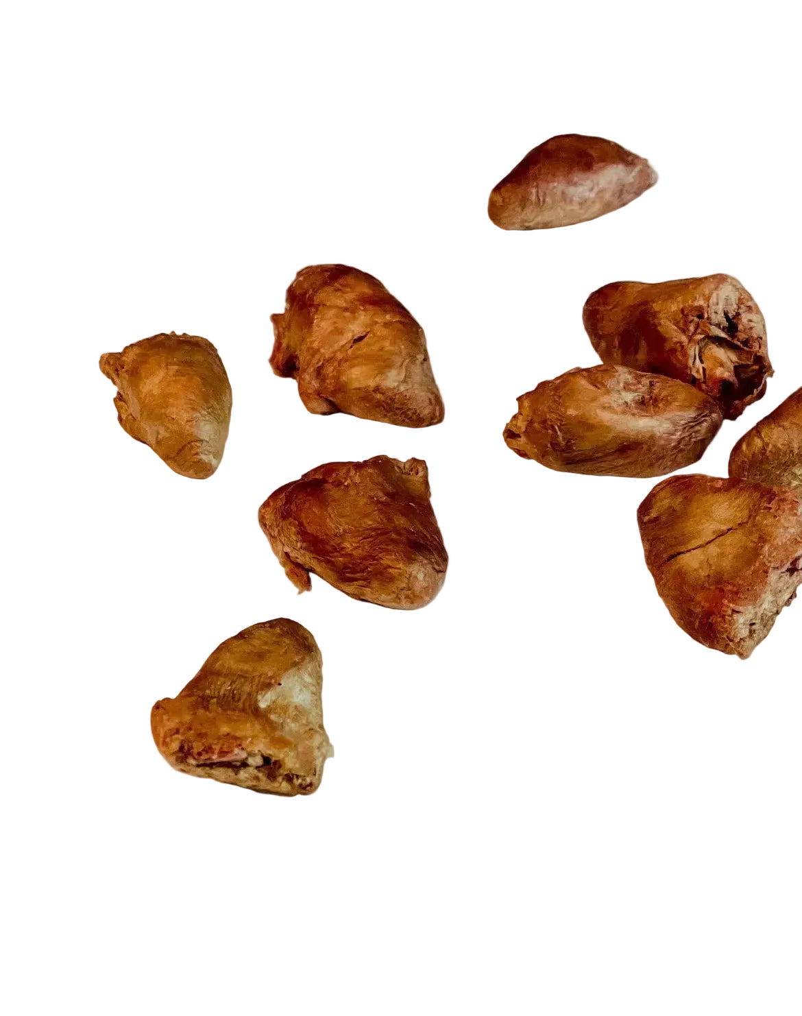 Brown dried fruits or seeds scattered on a white background