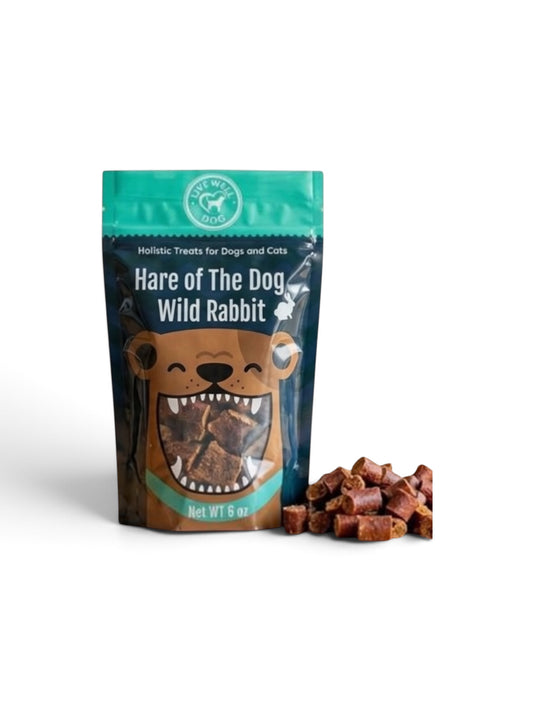 A stand-up pouch of Wild Rabbit Hare of the Dog treats with a cartoon bear graphic, shown next to a small pile of brown rectangular dog treats on a white background.